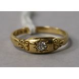 A Victorian 22ct gold and single stone diamond ring with carved shoulders, size P.