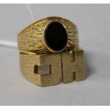 A gentleman's yellow metal and black onyx signet ring (tests as 9ct) and a 'JH' 9ct gold signet