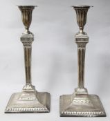 A pair of George III silver candlesticks, by Sutton & Bult, London, 1782, (both repaired), 30.9cm.