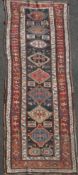 A Kazak blue ground runner, c.1880, with eight central stepped medallions in a field of animals