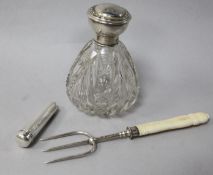 A George V silver mounted glass scent bottle, a silver fork and a silver cased amber cigarette