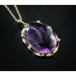 A large oval facet cut amethyst pendant in yellow metal mount on 9ct gold fine link chain, gross
