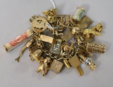 A 9ct gold charm bracelet hung with 41 charms (various) and with padlock clasp.