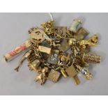 A 9ct gold charm bracelet hung with 41 charms (various) and with padlock clasp.