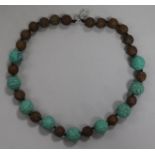 A carved turquoise and agate bead necklace.