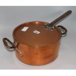 A copper two handled pan with lid
