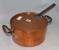 A copper two handled pan with lid