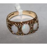 A 9ct gold, three stone white opal and diamond chip set dress ring, size O.