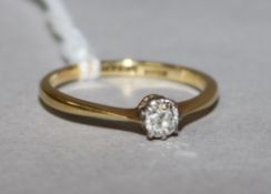 An 18ct gold and platinum solitaire diamond ring, size L.