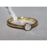 An 18ct gold and platinum solitaire diamond ring, size L.
