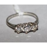 A platinum and three stone diamond ring, size H.