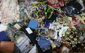 A large quantity of assorted costume jewellery including silver medallions and two lacquer boxes.