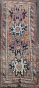 A Derbend apricot ground rug, c.1910, with four geometric motifs in a field of flower heads, 9ft 6in