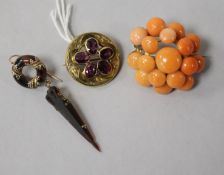 A Victorian gold and garnet circular brooch, a similar tortoiseshell and gold pique earring and a