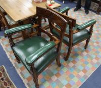 A pair of Victorian mahogany armchairs, with green leather seats