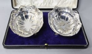 A cased pair of George V silver oval pierced bon bon dishes by Joseph Gloster Ltd, 14cm.
