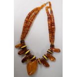 A large amber necklace, with assorted shaped beads, gross 221 grams.