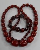 A single strand graduated simulated cherry amber necklace and a similar bracelet.
