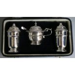 A cased George V three piece silver condiment set