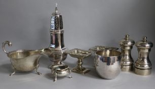 A pair of modern silver pepper mills, a sauceboat, a pair of Continental pedestal salts and three