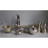 A pair of modern silver pepper mills, a sauceboat, a pair of Continental pedestal salts and three