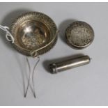 A George V silver tea strainer, a gold mounted cigarette holder with silver case and a silver bottle