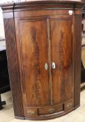 A George III mahogany bowfront corner cupboard, W.84cm