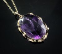 A large oval facet cut amethyst pendant in yellow metal mount on 9ct gold fine link chain, gross