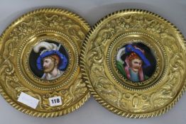 A pair of brass and ceramic plaques