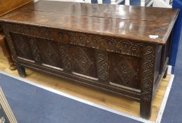 An 18th century later carved oak coffer, W.150cm