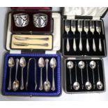 Five cased sets of small silver: a pair of napkin rings, a pair of butter knifes, six coffee bean