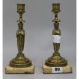 A pair of brass figurative candlesticks