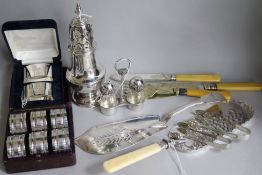 A George III silver fish slice, a silver sugar caster, a cased pair of silver napkin rings, an