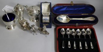 A George VI three piece silver condiment set, a cased set of six coffee spoons, a cased