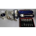 A George VI three piece silver condiment set, a cased set of six coffee spoons, a cased