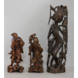 Two Chinese carved figures and another