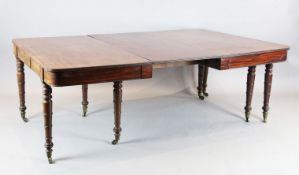 A large Regency mahogany extending dining table, with D shaped ends and three leaves, on ring turned