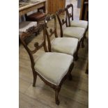 A set of four William IV colonial carved rosewood salon chairs