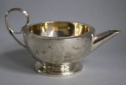 A George IV silver cream jug, marks rubbed
