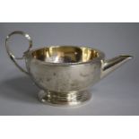 A George IV silver cream jug, marks rubbed