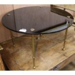 A black glass topped brass occasional table, W.70cm