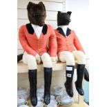 Two toy seated foxes in huntsman outfits