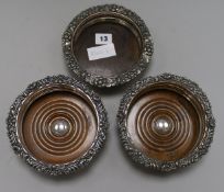 A pair of plated wine coasters and another