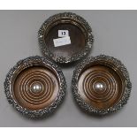 A pair of plated wine coasters and another