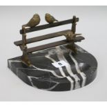 A Vide de Poche Art Deco bronze birds on a bench, on a marble base