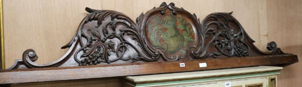 A Victorian carved and painted oak pediment, with central crest, removed from a Masonic Hall, now