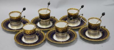 An Aynsley gilt and blue coffee set with silver holders and spoons