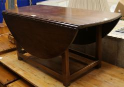 A George III style mahogany circular drop leaf low table, W.125cm