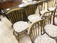 An Ercol oak drop leaf dining table with a set of four beech chairs