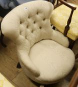 A Victorian button-back sewing chair, upholstered in ivory fabric, on turned legs